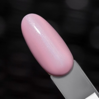 Amostra de verniz rosa claro brilhante e cintilante num suporte cinzento