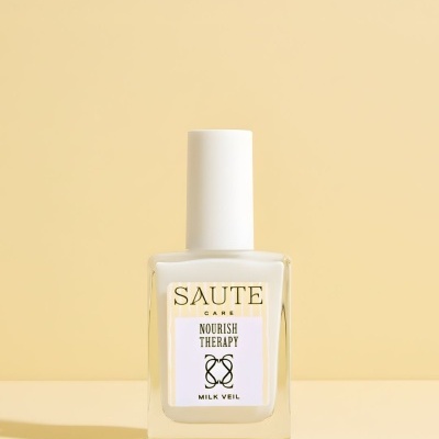 Frasco de vidro com tampa branca e rótulo com texto SAUTE CARE NOURISH THERAPY MILK VEIL