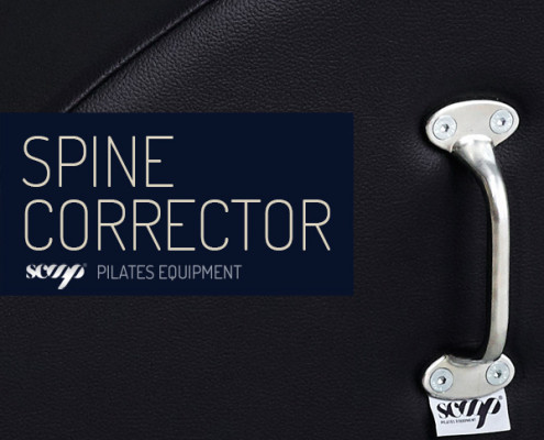 Equipamento 'Spine Corrector' de pilates com pega metálica e base preta