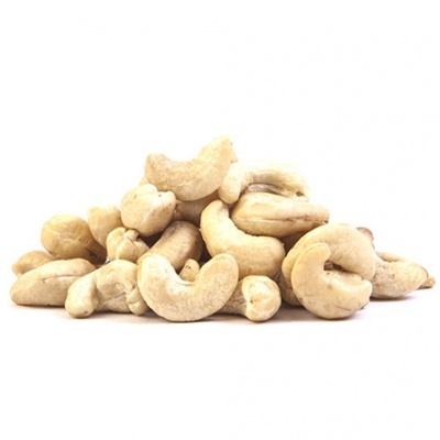 pile of whole beige cashew nuts on white background