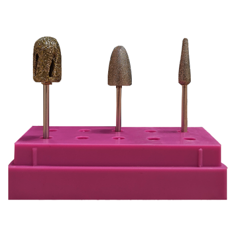 Três brocas douradas para manicure em suporte rosa