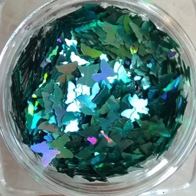 Pote com lantejoulas de borboletas holográficas verde-azuladas