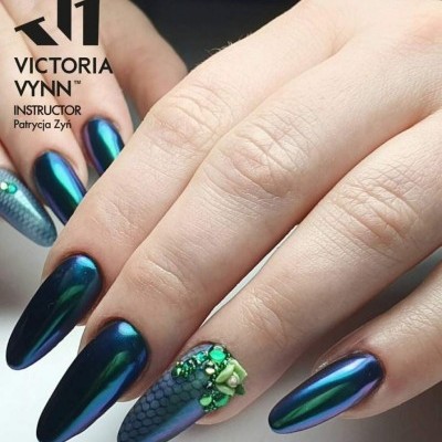 Unhas azuis metálicas e decoradas com pedrinhas verdes e padrão escama de peixe