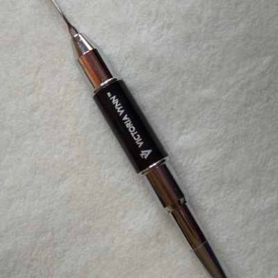 Ferramenta de manicure em metal com ponta fina e pincel, corpo preto com texto branco VICTORIA VYNN