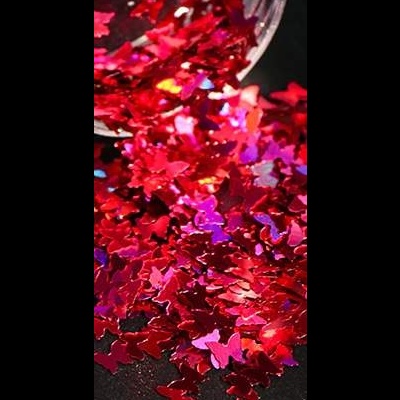 Confetes vermelhos metálicos em forma de borboletas derramando de recipiente