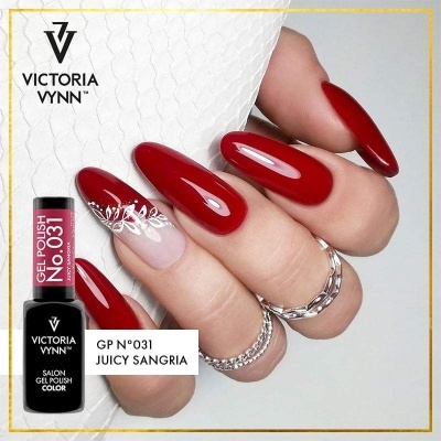 Unhas vermelhas com desenho branco e embalagem de verniz gel preta da marca Victoria Vynn