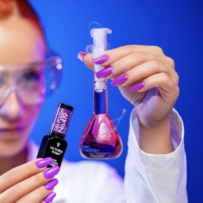 Mulher segura verniz gel e tubo de ensaio com líquido rosa