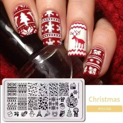 Unhas decoradas com padrão de Natal em vermelho e branco com placa de estampagem ao lado