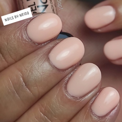 Unhas pintadas cor de rosa suave com brilho e texto Nails by Neida invertido