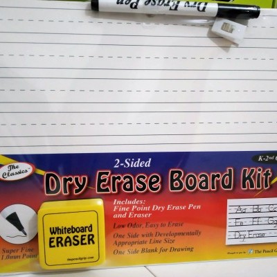 Kit de quadro branco, apagador e caneta num fundo com embalagem colorida