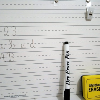 Papel pautado para caligrafia com texto, caneta apagável preta e borracha amarela para quadro branco