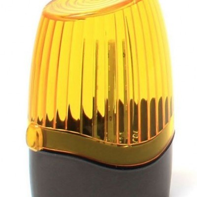 Luz de aviso amarela com base preta e cúpula de plástico estriada