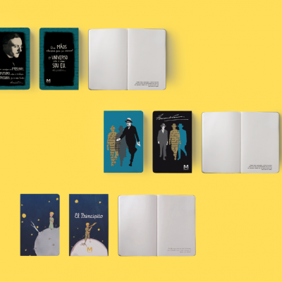 Três cadernos ilustrados com capas coloridas e textos em português e espanhol sobre um fundo amarelo