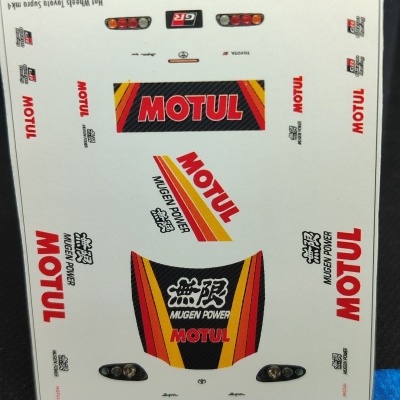 Autocolantes de modelo de carro com logos MOTUL, MUGEN POWER, Toyota e Toyota Supra em folha branca com régua ao lado.