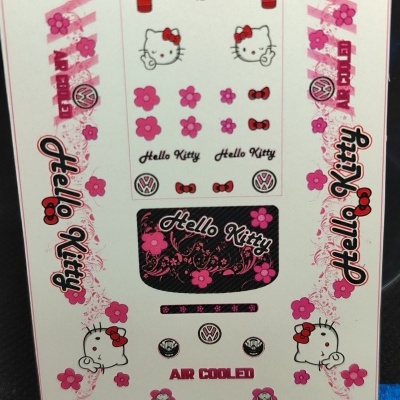 Folha de autocolantes decorativos Hello Kitty e Volkswagen com flores e texto diversos.