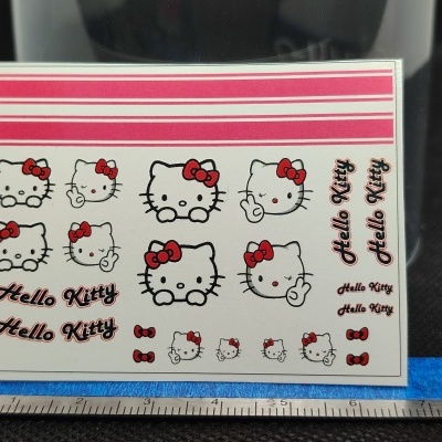 Folha autocolante branca com várias imagens de Hello Kitty e texto Hello Kitty