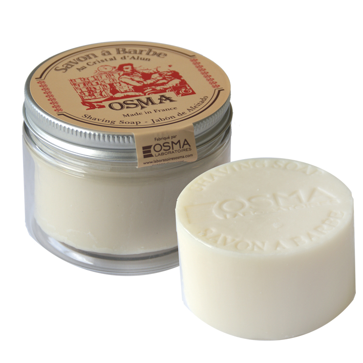 Osma Sabão De Alúmen barbear 100gr Sabonete de barbear OSMA em frasco transparente com tampa dourada e sabonete redondo branco.