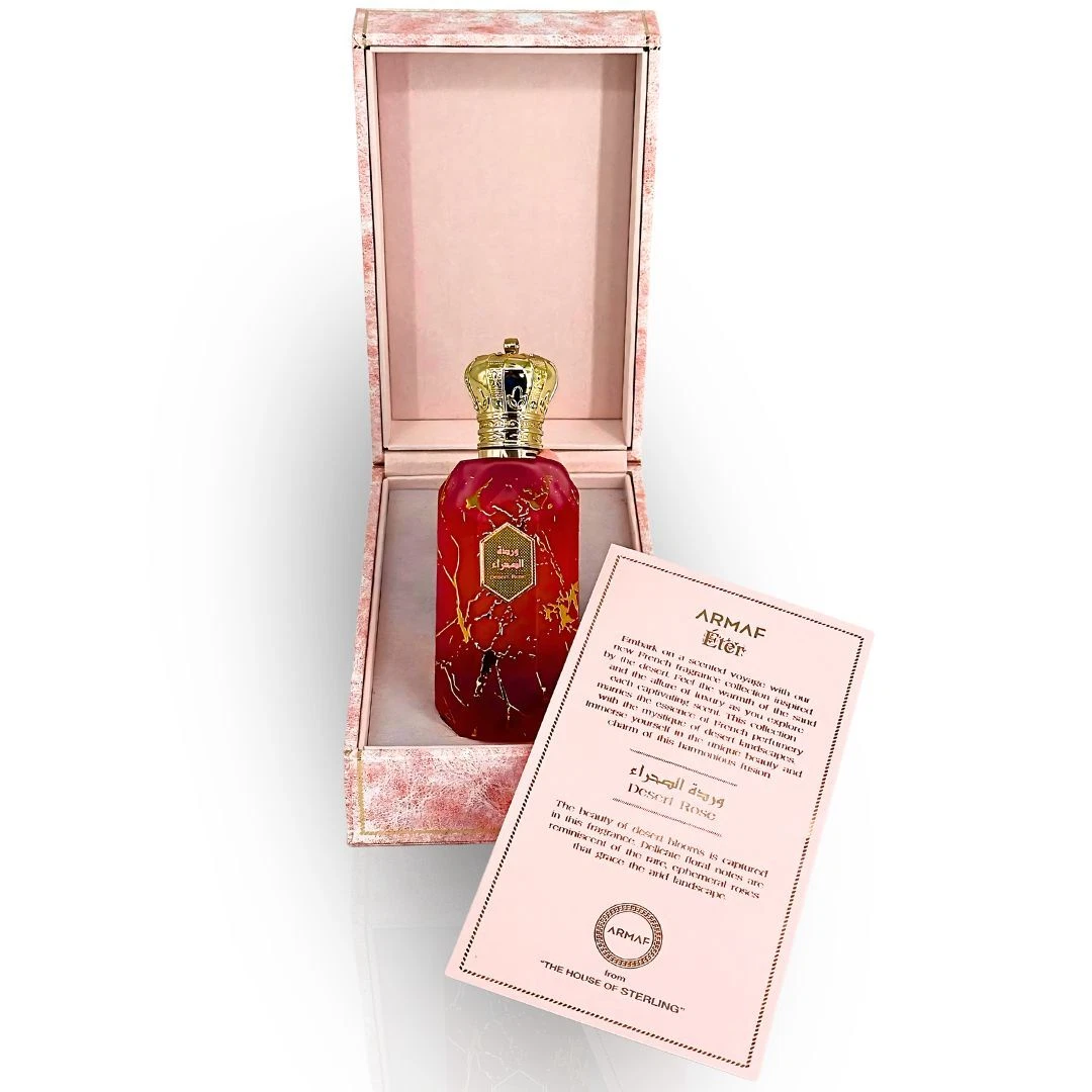 Armaf Eter Desert Rose Eau De Parfum 100 ml Frasco de perfume vermelho com tampa dourada em forma de coroa dentro de caixa rosa com cartão explicativo.