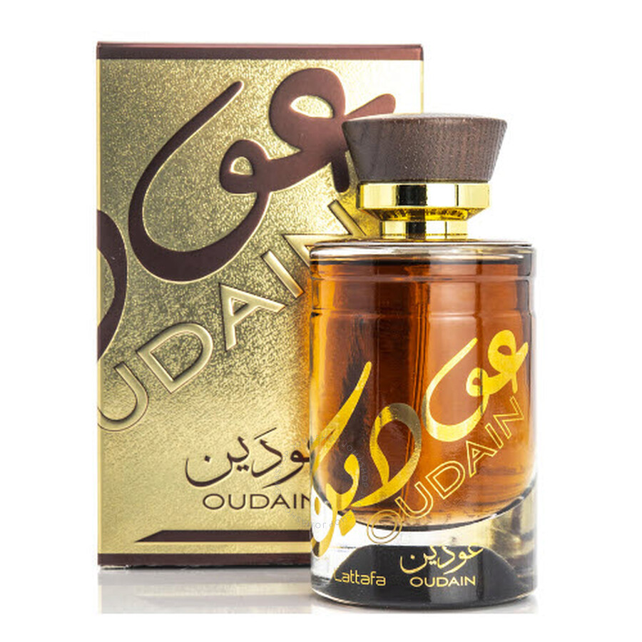 Oudain Lattafa Unissex 100ml (Original) Frasco de perfume âmbar com tampa marrom e dourada ao lado de caixa dourada com texto OUDAIN