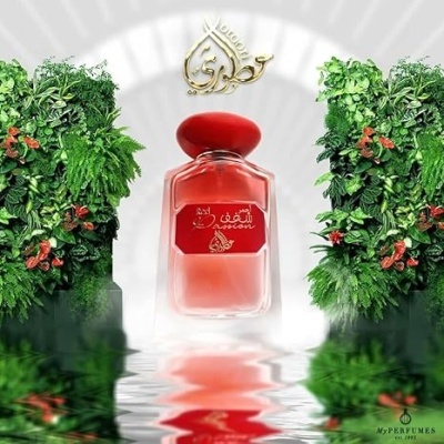 frascos de perfume vermelho com decoração verde e reflexo em água
