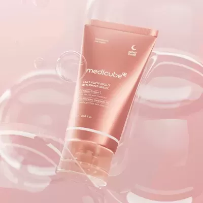 Máscara facial de noite em bisnaga rosa com tampa transparente e texto branco