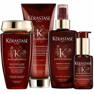 Produtos capilares Kérastase Aura Botanica em embalagens castanho escuro e dourado