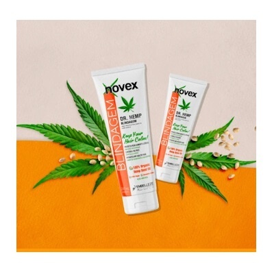 Duas embalagens de creme Novex DR. HEMP BLINDAGEM sobre folhas de cânhamo e sementes em fundo bege e laranja