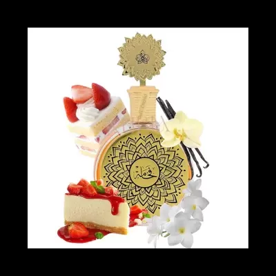 Frasco de perfume dourado com texto árabe rodeado por bolos e flores