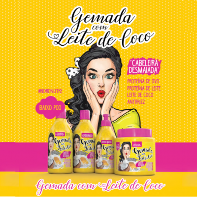 Produtos cosméticos 'Gemada com Leite de Coco' em embalagens amarelas e cor-de-rosa com desenho de mulher e fundo amarelo com padrão de pontos