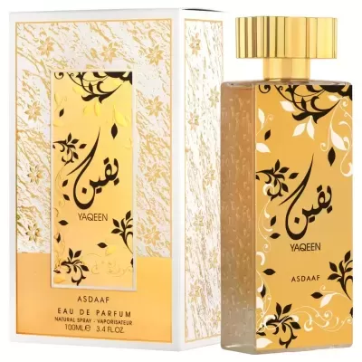Frasco e caixa de perfume dourado com padrão floral e texto em árabe e inglês