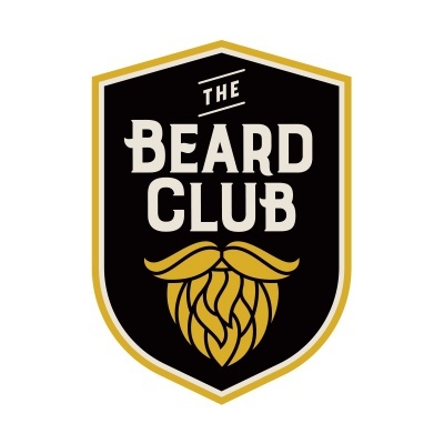 Logótipo do The Beard Club com texto e ilustração dourada de barba e bigode num escudo preto.