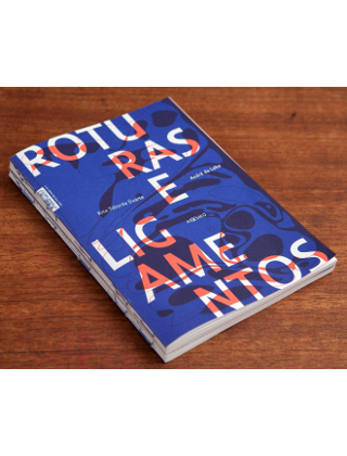 Roturas e Ligamentos Livro azul com texto branco e laranja sobre madeira