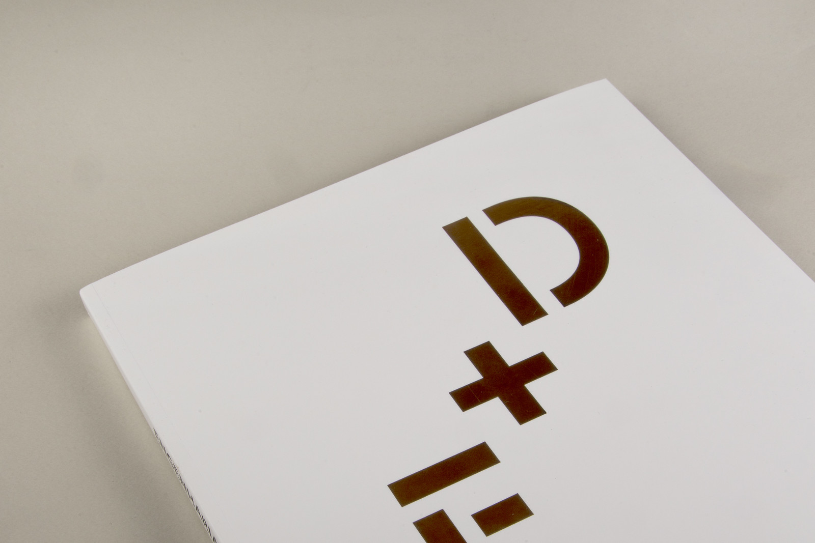 Engenharia + Design — Da Ideia ao Produto Pacote branco com caracteres dourados 'D+' em relevo