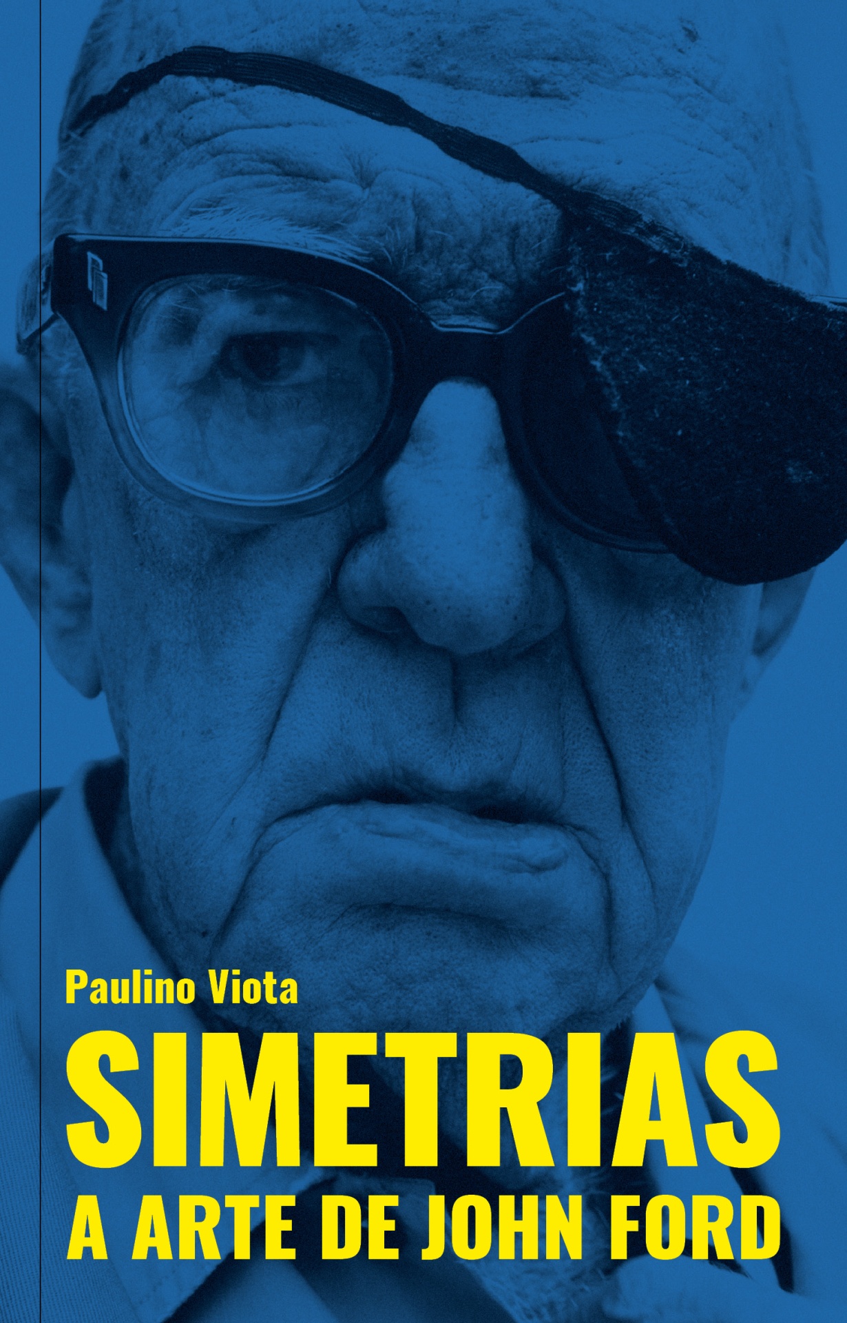 SIMETRIAS - A arte de John Ford Homem idoso com tapa-olho e óculos em fundo azul, texto amarelo do título do livro
