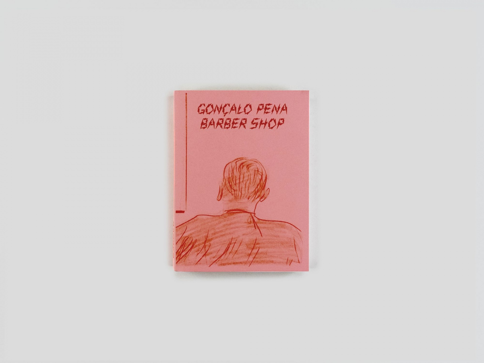 Gonçalo Pena: Barber Shop Livro rosa com ilustração de homem visto de costas e texto 'GONÇALO PENA BARBER SHOP'.
