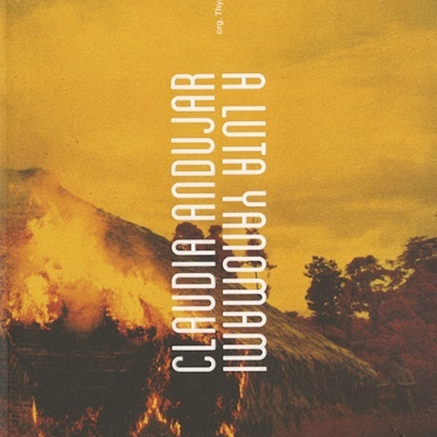 Capa de livro com cabana em chamas e texto vertical branco