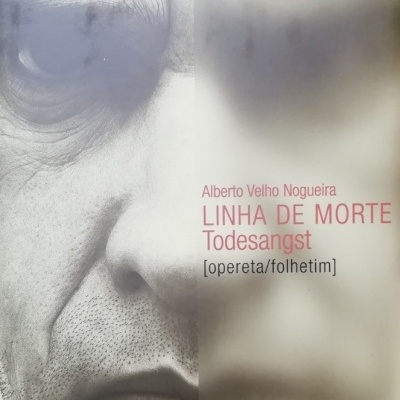 Capa de livro com rosto masculino em close e texto em vermelho e preto