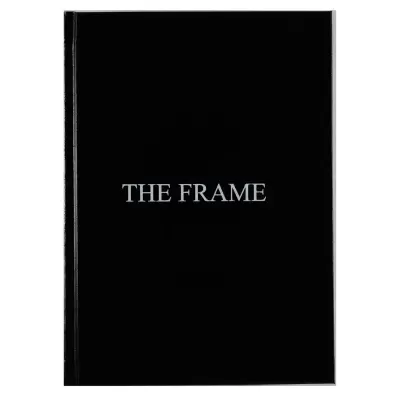 Livro preto com texto THE FRAME na capa