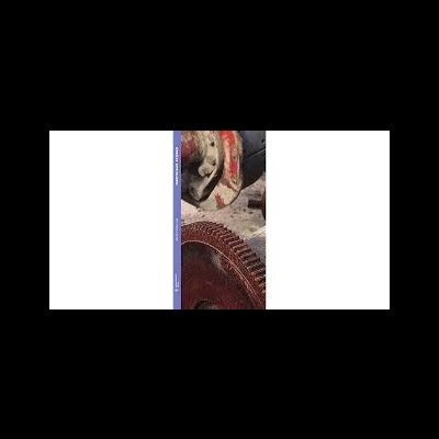 Máquina industrial com peças metálicas enferrujadas e roda dentada.