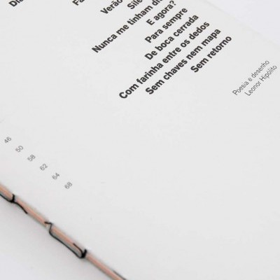 Livro aberto com poema em português e números de página visíveis