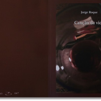 Livro 'Canção da vida' de Jorge Roque sobre superfície escura