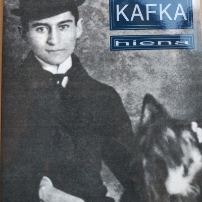 Capa de livro a preto e branco com fotografia de homem e cão com texto azul