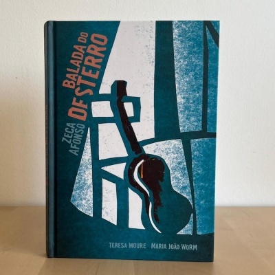 Capa de livro azul e branca com guitarra e texto