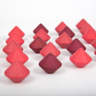 Peças triangulares de madeira vermelhas e roxas sobre fundo branco