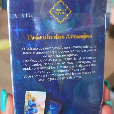 Pacote de oráculo dos arcanjos com fundo azul e dourado, texto descritivo em português e duas cartas visíveis