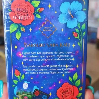 Embalagem azul decorada com flores vermelhas e azuis de um baralho de cartas mystic
