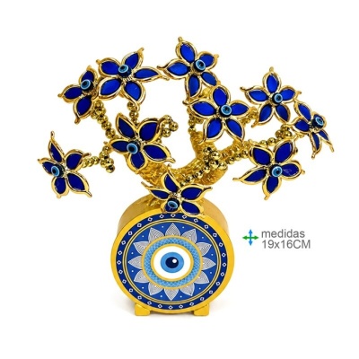 Objeto decorativo dourado com flores azuis e olhos azuis no centro em base circular azul
