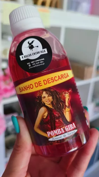 Frasco de banho de descarga com líquido vermelho e rótulos coloridos