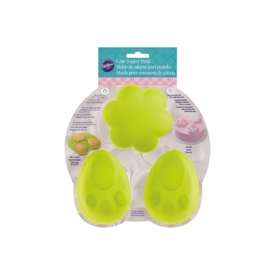 Molde de silicone verde para decoração de bolos com formas de patinha e flor, embalagem em cartão branco