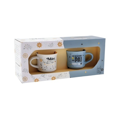 Conjunto de duas canecas em cerâmica, uma branca com texto alusivo a mãe e outra azul com texto alusivo a pai, em caixa decorada.